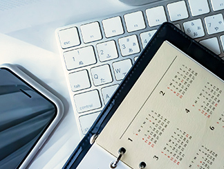 手帳・PC・スマートフォンが並んだイメージ画像